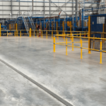 Industrial factory floor with machinery and safety railings