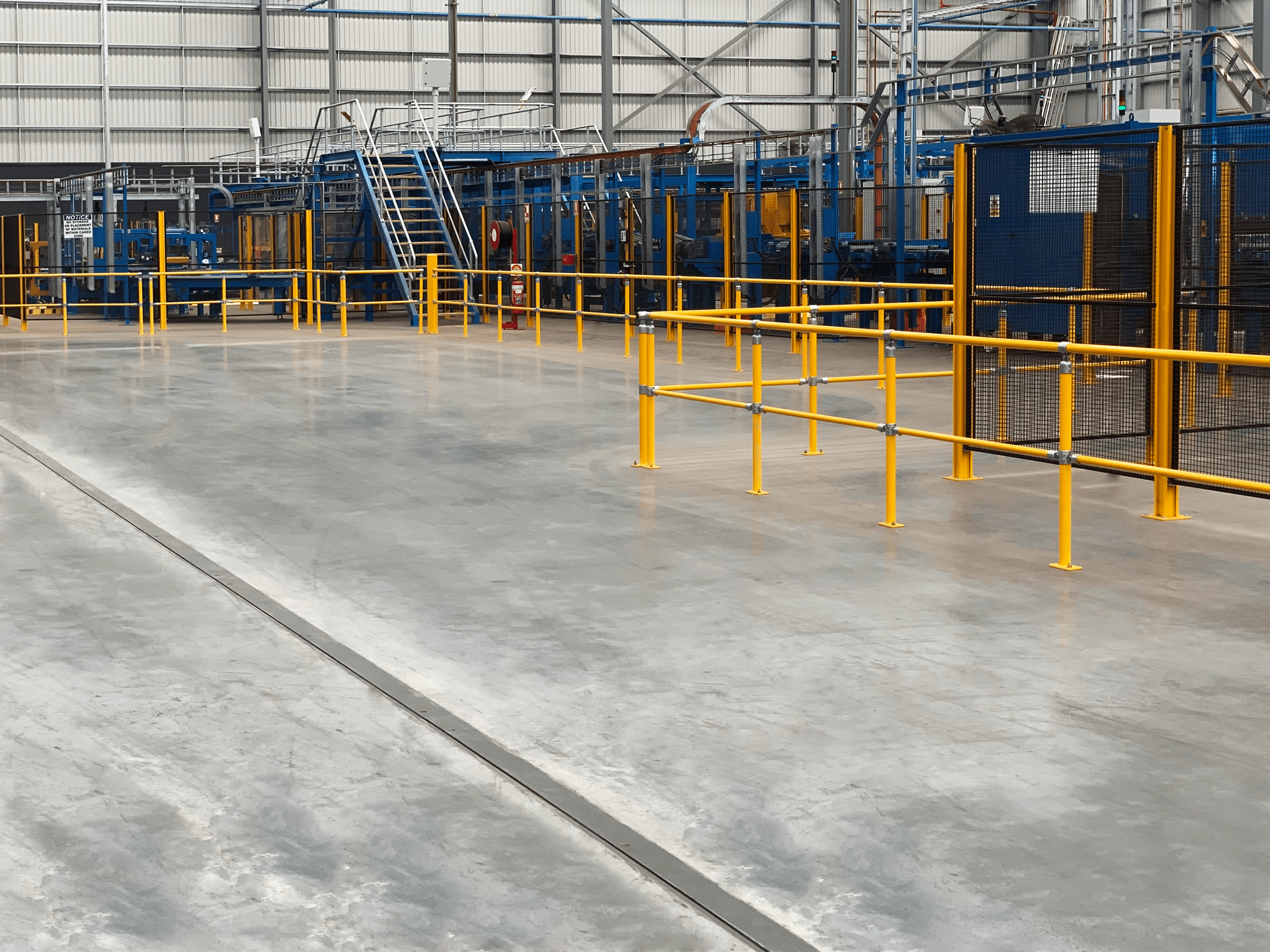 Industrial factory floor with machinery and safety railings
