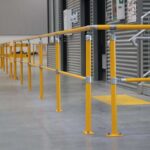 Yellow industrial safety handrails inside warehouse facility