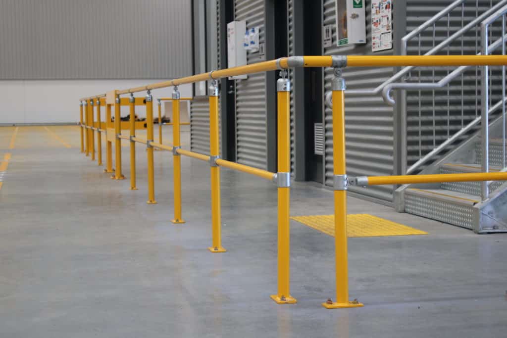 Yellow industrial safety handrails inside warehouse facility