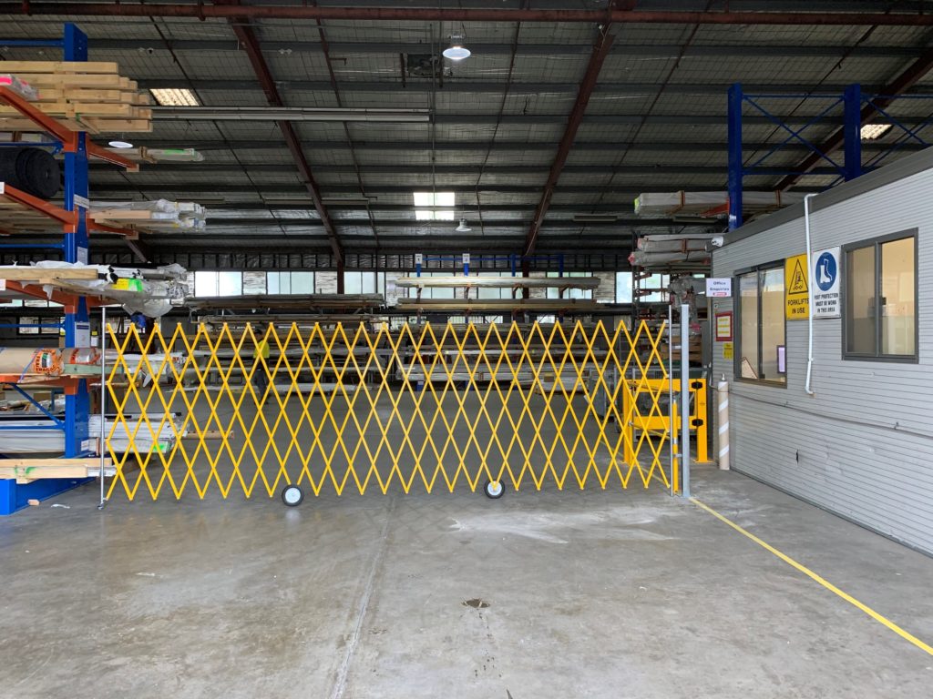 Interior of a warehouse with yellow safety barrier.