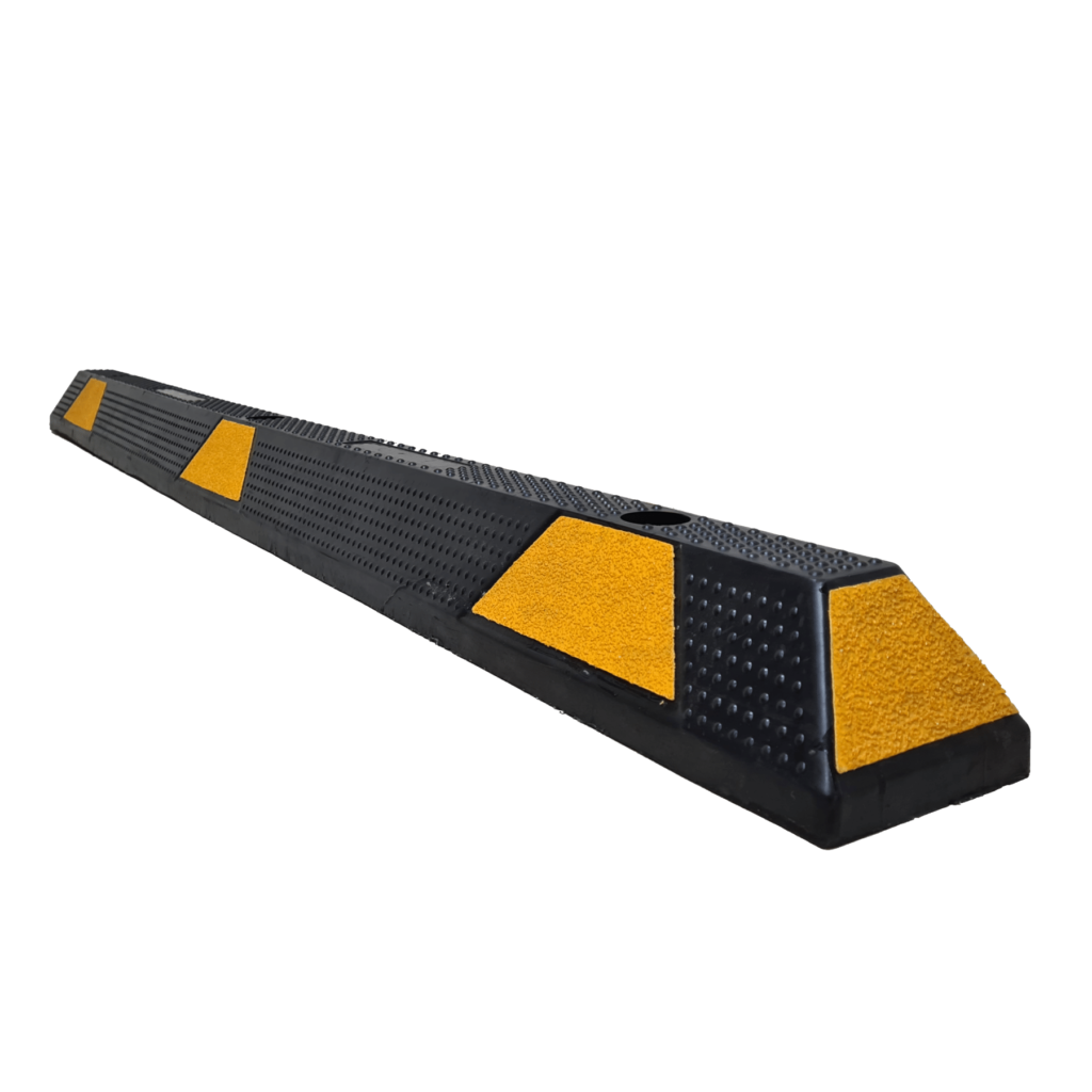 A black rubber speed bump with yellow markings.