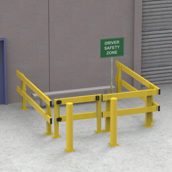 Driver safety zone enclosed by yellow safety barriers near an industrial building, featuring a green "Driver Safety Zone" sign and a nearby loading dock.