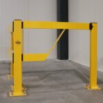 Bright yellow barrier in a warehouse setting.
