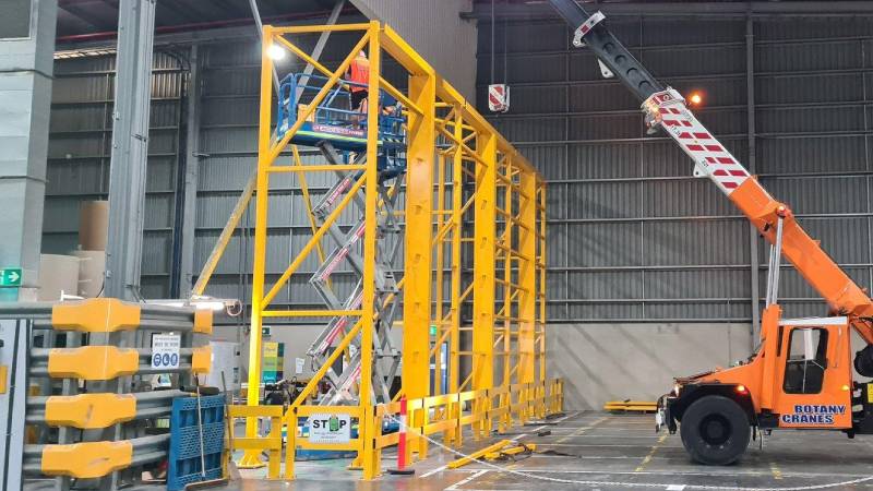 Construction site with scaffolding and crane.