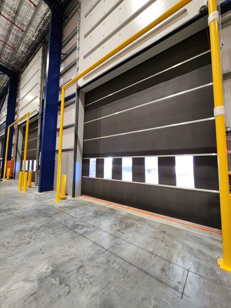 Industrial loading dock with automated roller doors.
