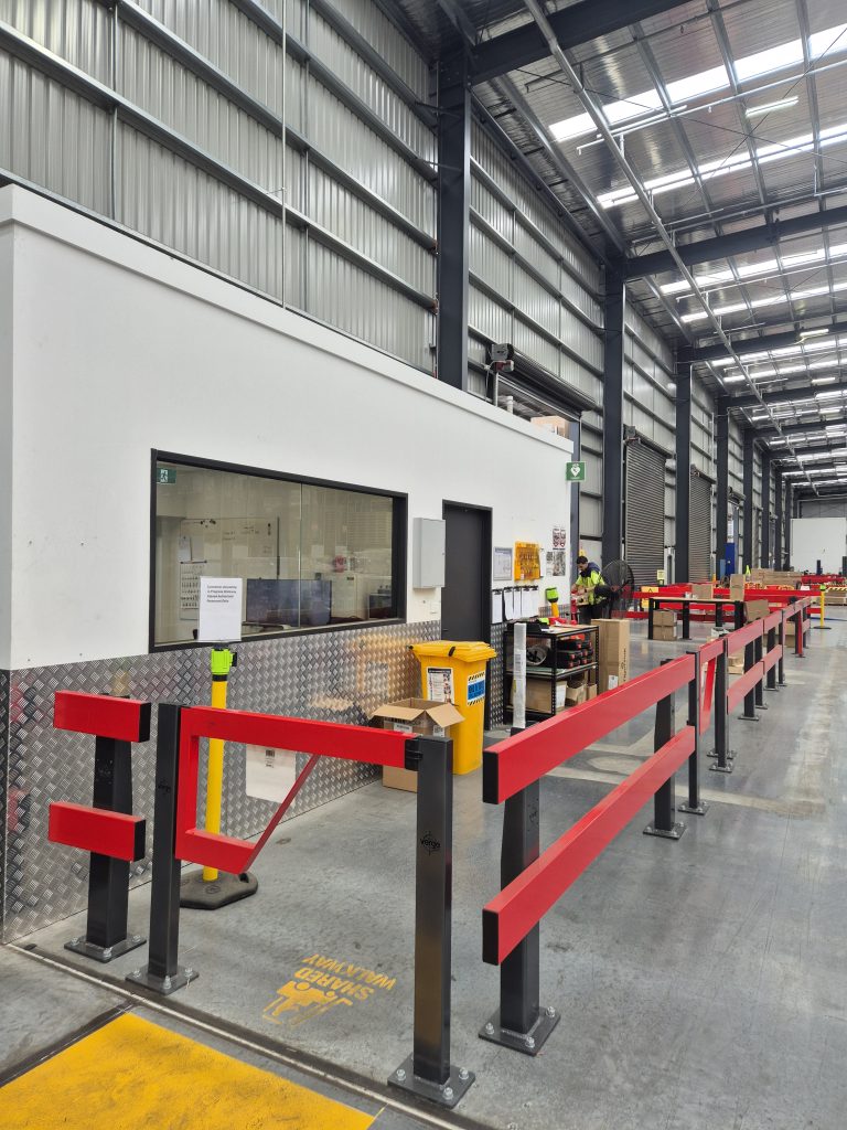 Interior view of a workspace with safety barriers.