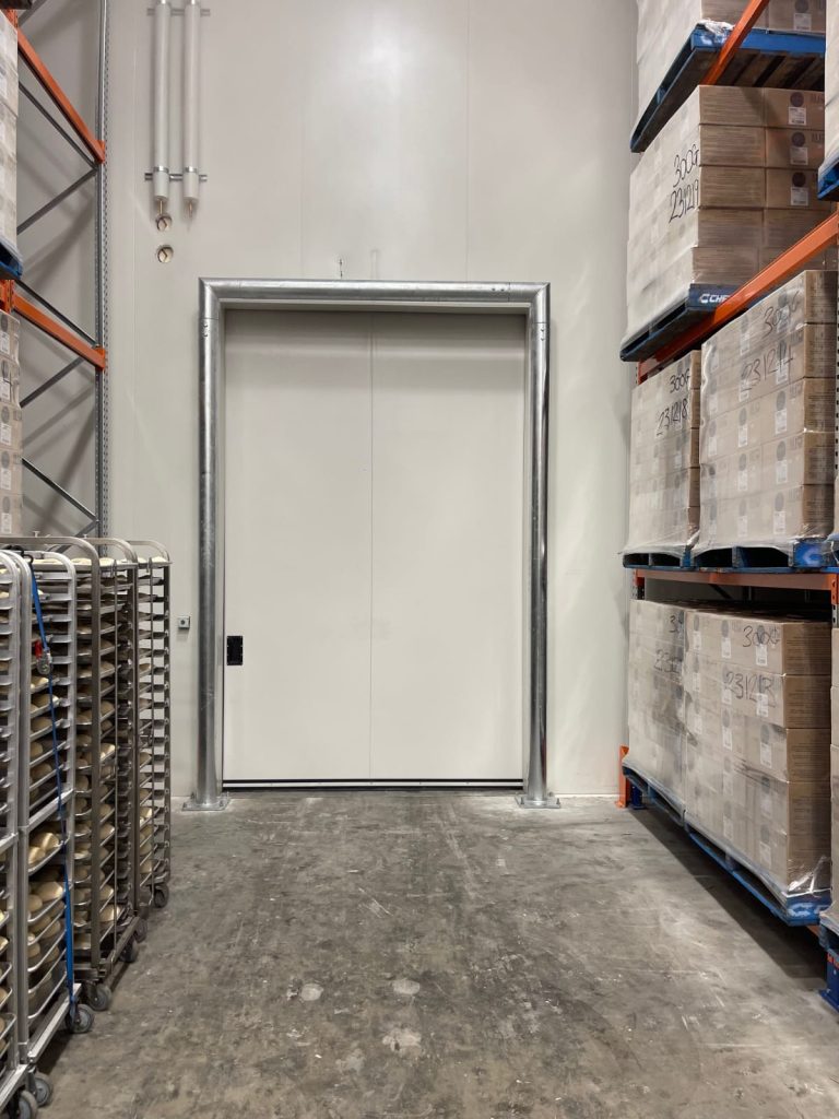 Warehouse interior with a large loading door.