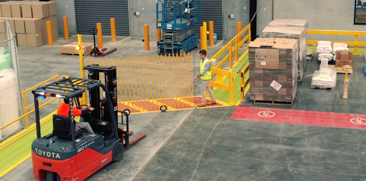 Forklift operating in a warehouse loading area.