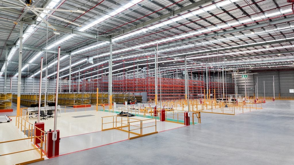 Spacious warehouse interior with storage racks.