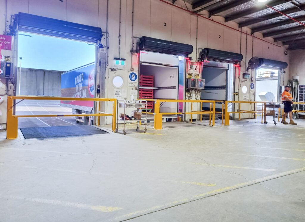 Warehouse loading area with open dock doors.