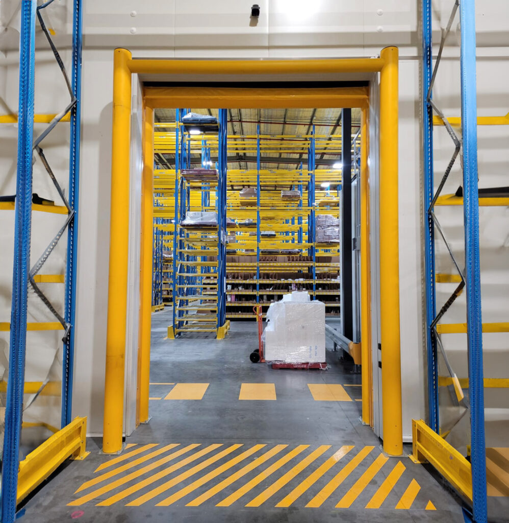 Warehouse aisle with safety bollards and storage racks