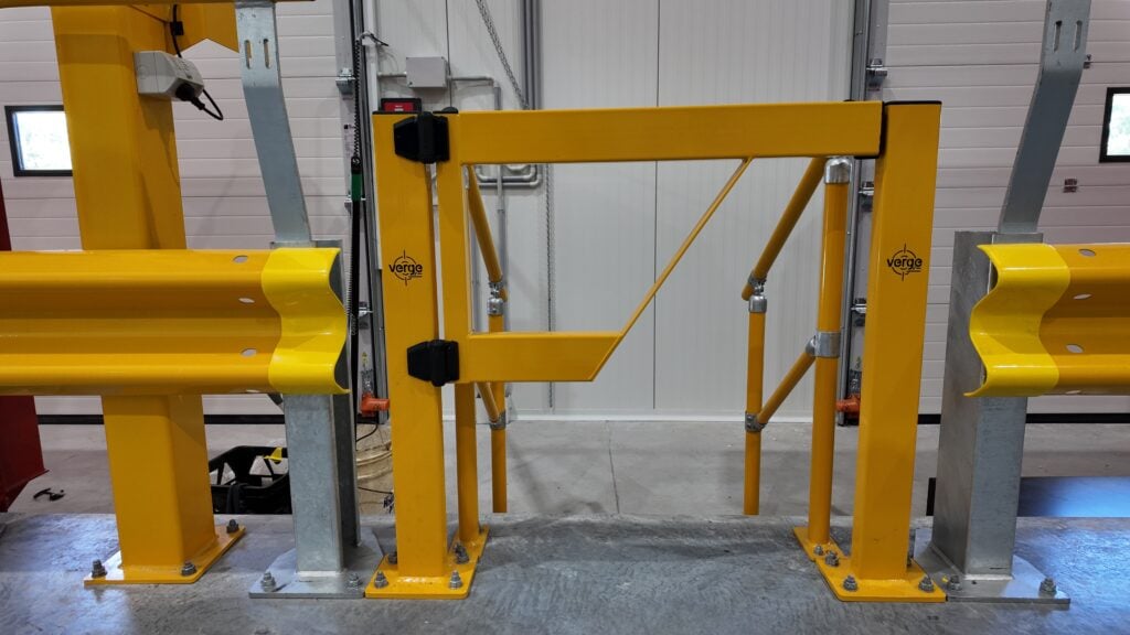 Yellow industrial safety gate in warehouse loading area