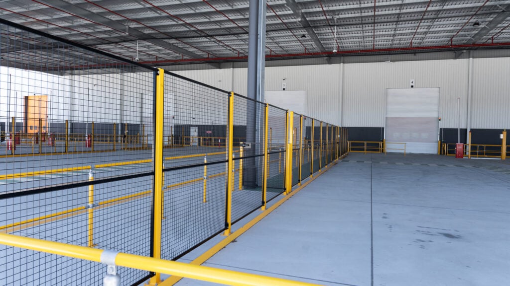 Industrial warehouse interior with yellow safety fencing