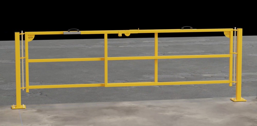 Yellow industrial safety barrier gate on concrete floor