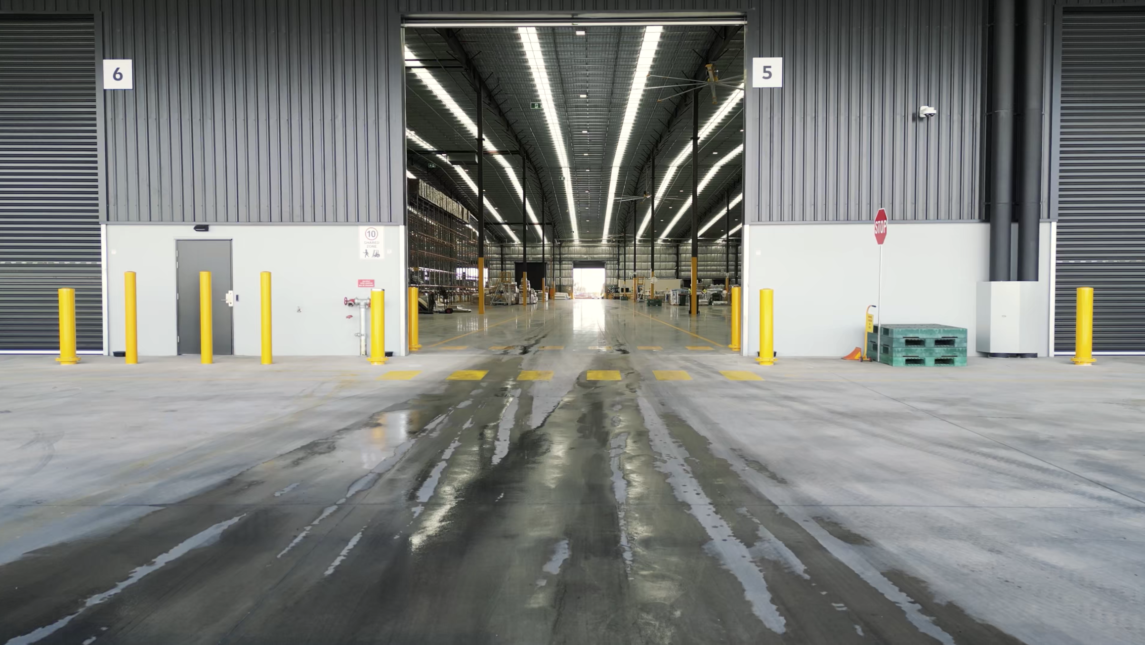 Open loading bay leading into a modern warehouse