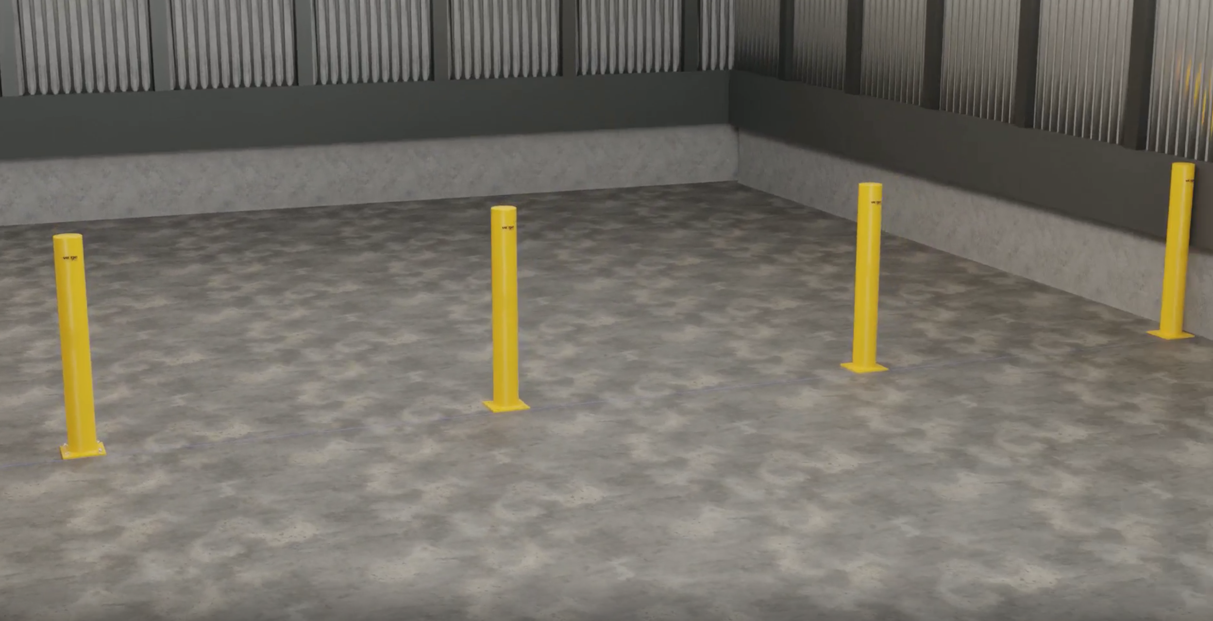 Four yellow bollards in an empty concrete warehouse