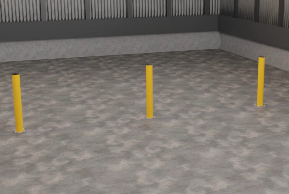 Three yellow safety bollards on a concrete warehouse floor