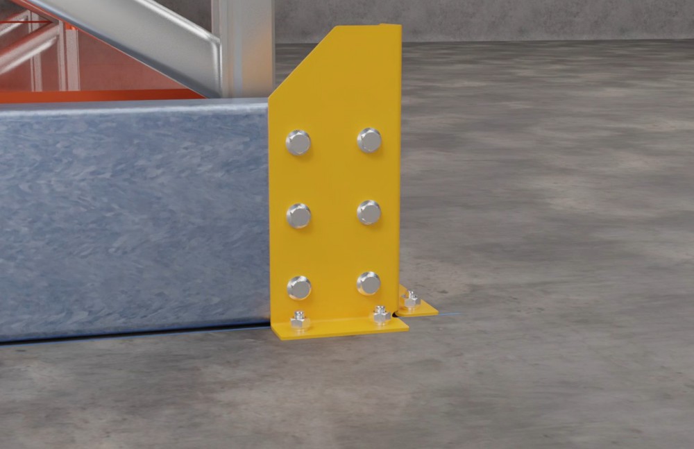 Yellow steel guard bolted beside warehouse racking beam