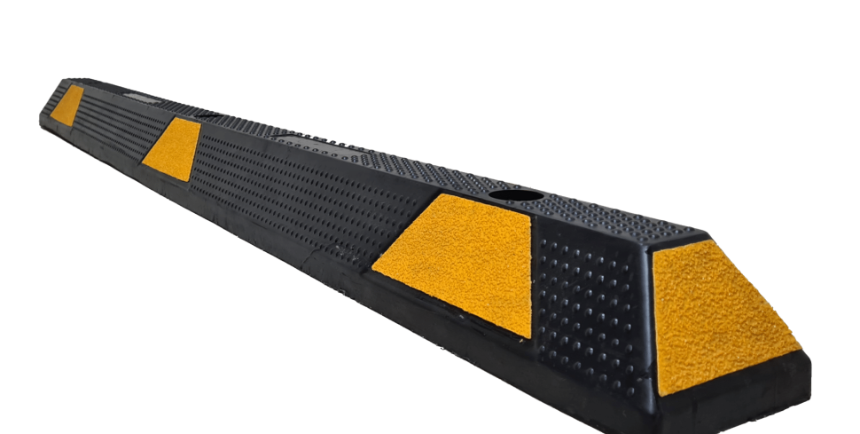 A black rubber speed bump with yellow markings.